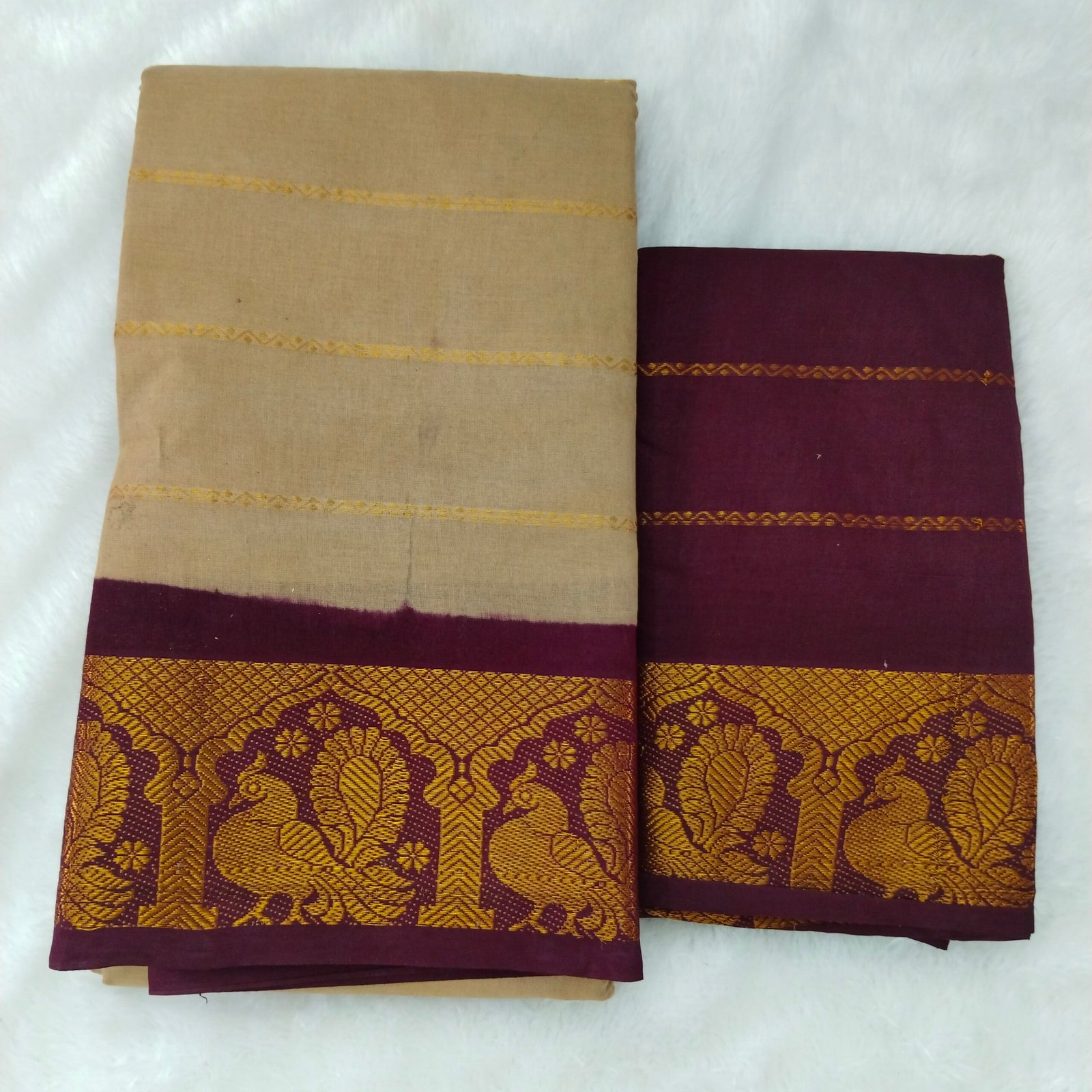 Earthy tusser tones contrasted by a dark meroon border; elegant pallu and blouse complete the set.
