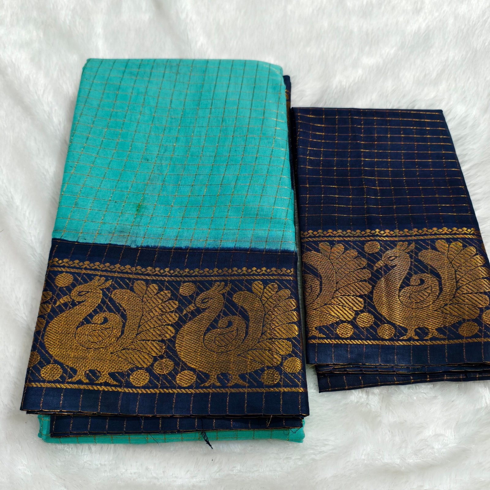A premium soft cotton handloom Sungudi saree featuring gold zari kattam checks and a matching blouse—elegant, lightweight, and traditionally crafted
